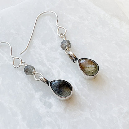 Close-up of Labradorite drop earrings with silver hooks and gemstones