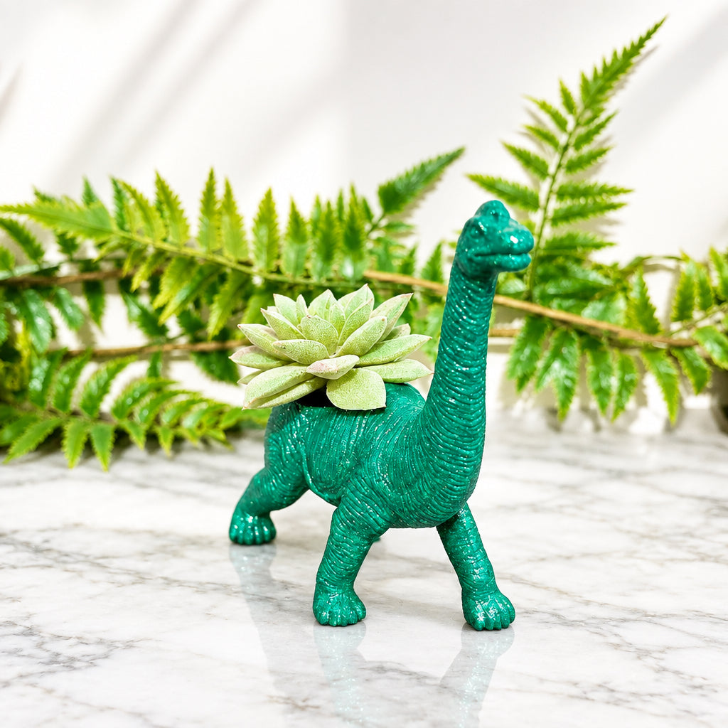 66a52de5c47c9c3ce95361c2_glittery-green-apatosaurus-dinosaur-planter-front_1790451448884.jpg