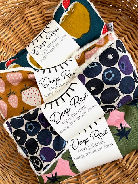 Colorful fruit-patterned eye pillows in basket