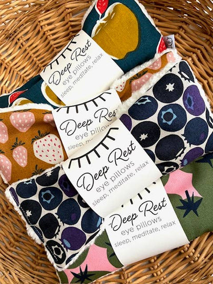 Colorful fruit-patterned eye pillows in basket
