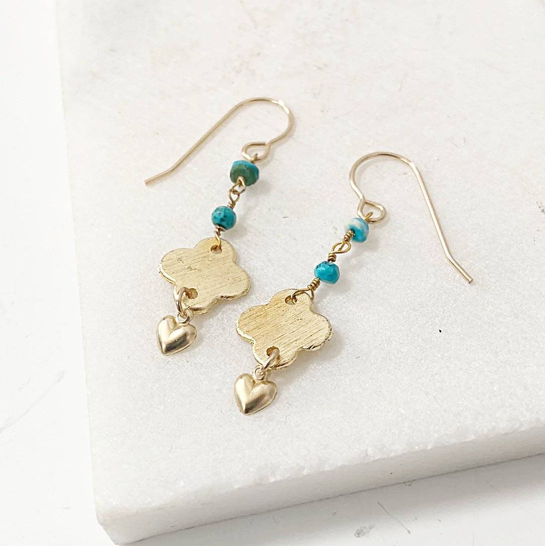 Versatile turquoise chain earrings with gold quatrefoil and heart charms, ideal for timeless jewelry collections and elegant accessorizing.