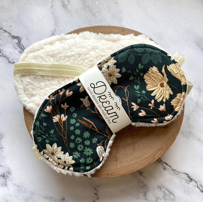 Emerald Sleep Mask with floral print and soft white minky backing, displayed on a wooden tray for home relaxation and sleep comfort.