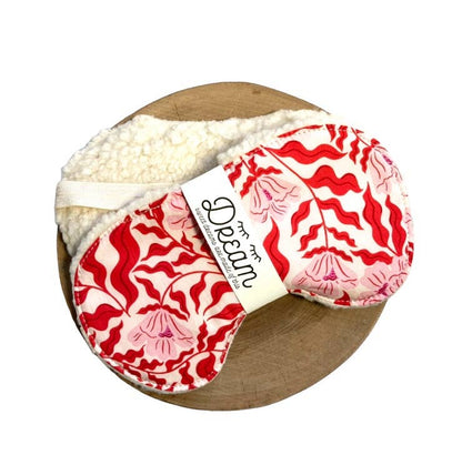 Sleep Mask - Sweet Dreams | Red Vine Edition featuring red and pink abstract floral design on cotton, displayed on a wooden board with soft minky backing.