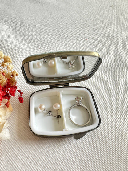 Open Floral Embroidered Jewelry Box - Elegant Storage with mirror, showcasing pearl earrings and a silver ring in a white interior compartment.