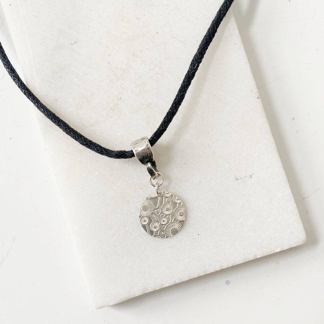 Silver Dandelion Medallion Necklace by Uni-T on black cotton cord, featuring engraved dandelion design in sterling silver for elegant styling.