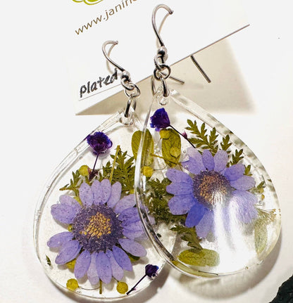 Teardrop resin earrings with purple daisy flowers and silver hooks. Elegant pressed flower earrings with a botanical theme.