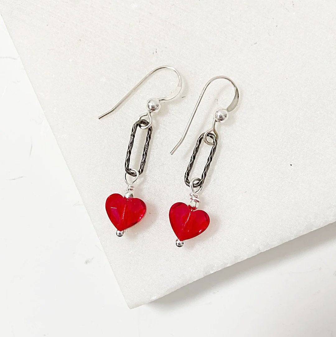 Red Heart Earrings - Standout Jewelry with Red Crystals featuring sterling silver hooks and Austrian red crystal heart beads on a white surface.