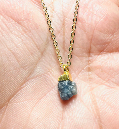 Gold chain with raw gemstone pendant jewelry on hand