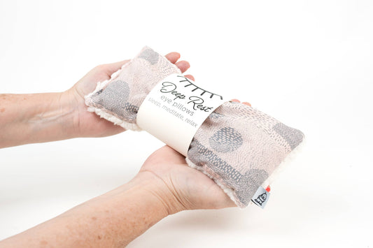 Hands holding Weighted Eye Pillow for Relaxation | Stress Relief Aid with plush cotton texture, ideal for calming and tension relief.
