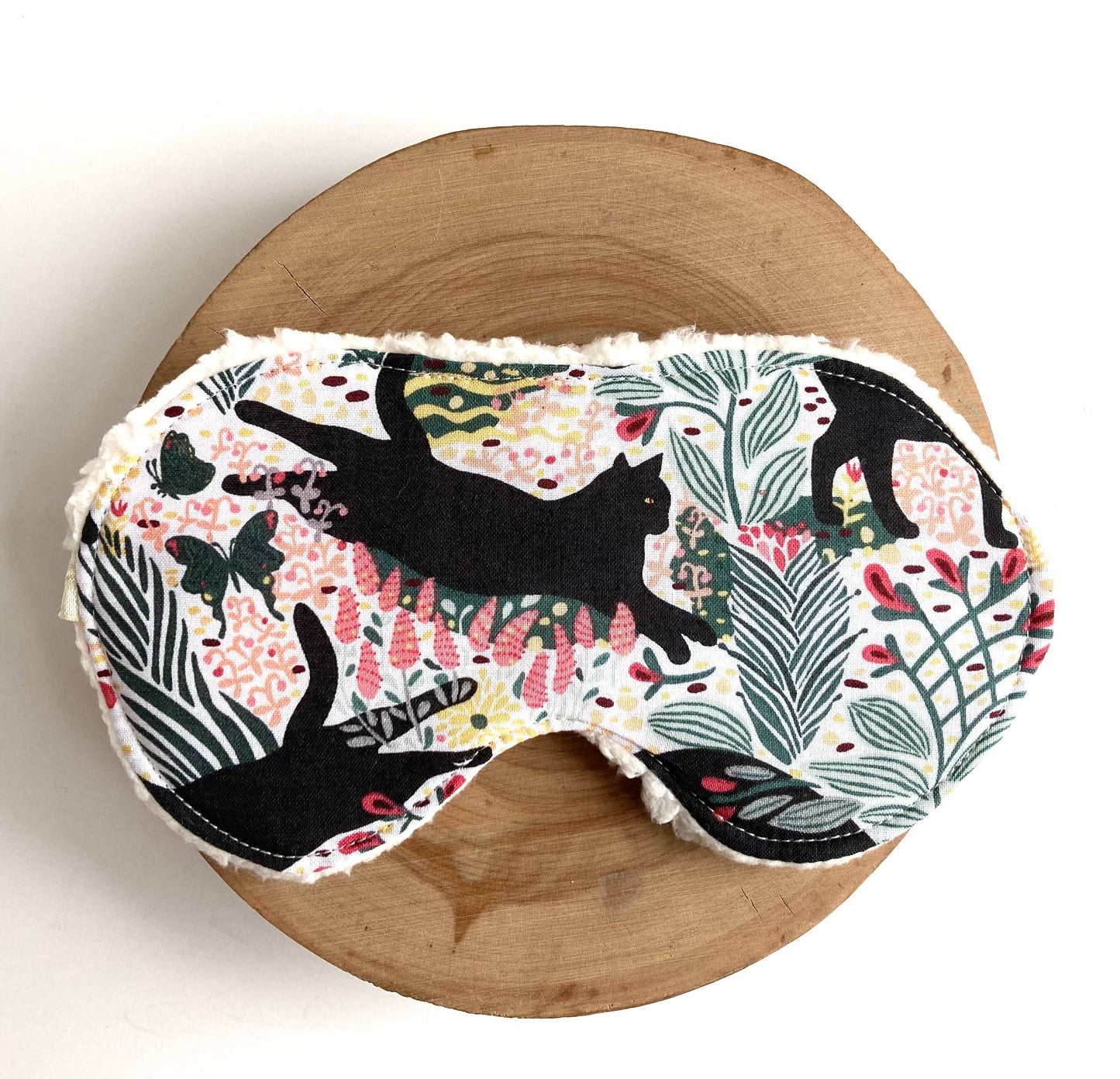 Front view of Jungle Cat Sleep Mask showcasing vibrant cotton fabric with jungle-themed cat and leaf pattern for soothing sleep.