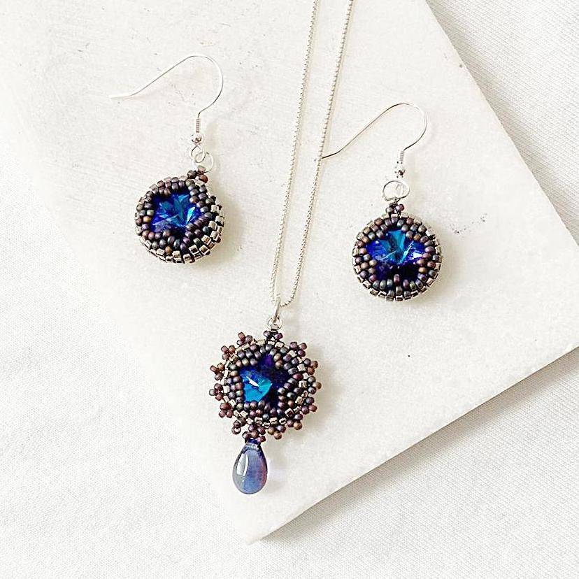 Beaded crystal necklace and earrings set featuring 12mm Austrian crystals in deep blue tones, perfect for elegant or formal wear.