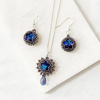 Beaded crystal necklace and earrings set featuring 12mm Austrian crystals in deep blue tones, perfect for elegant or formal wear.