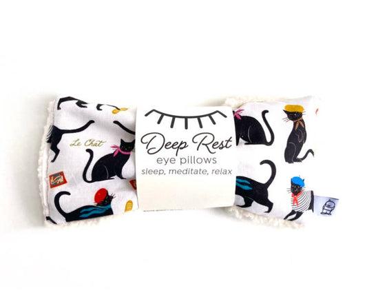 Deep Rest Eye Pillow with black cat print, designed for relaxation and meditation. Soft fabric ideal for stress relief and sleep support.