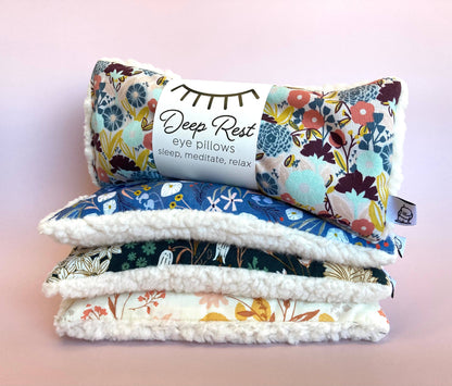 Stack of colorful weighted eye pillows including Emerald design, perfect for relaxation, acupressure, and anxiety relief routines.