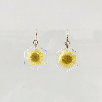 Hexagon resin earrings with yellow daisy flowers and gold hooks. From the Real Flower Earrings - Gold and Silver Posts series.