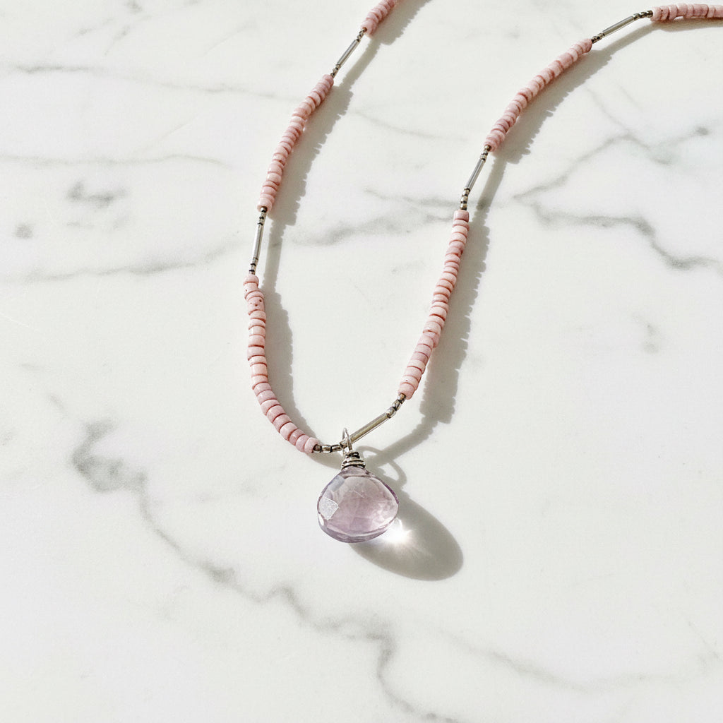 Pink beaded necklace with purple gemstone pendant