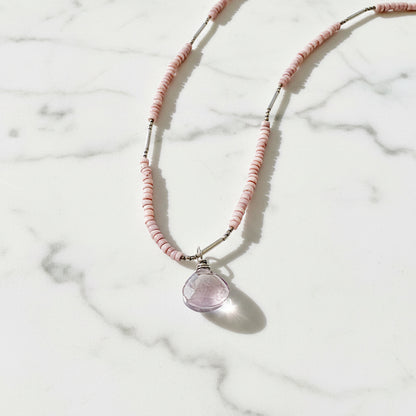 Pink beaded necklace with purple gemstone pendant