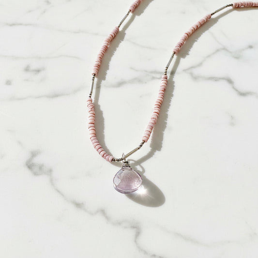 Pink beaded necklace with purple gemstone pendant