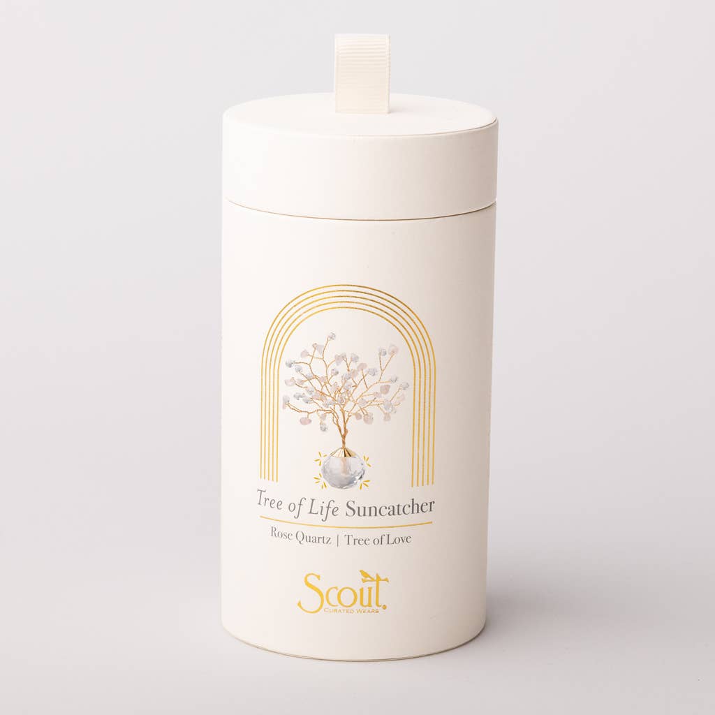 Elegant cylindrical packaging for Rose Quartz Suncatcher - Tree of Life by Scout, featuring gold foil design and product illustration.