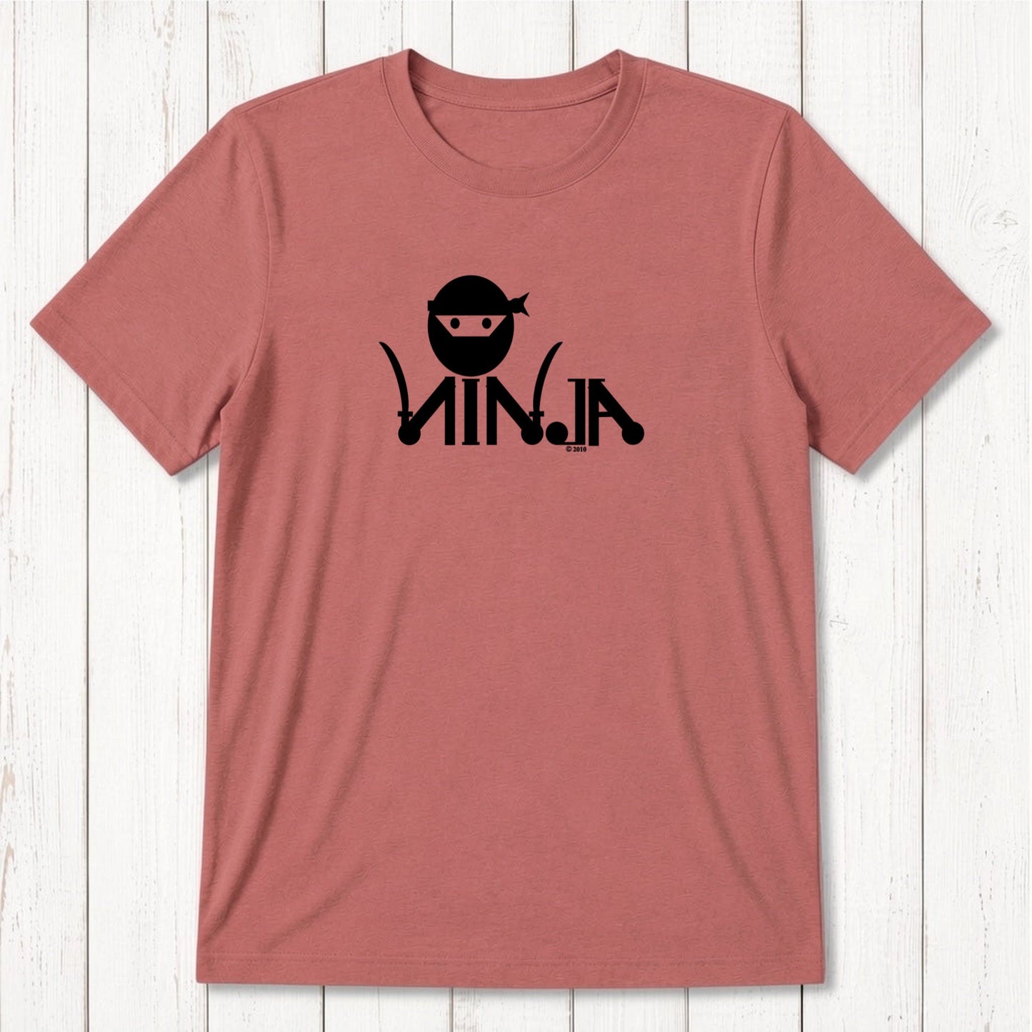 Pink men's T-shirt with black ninja graphic design featuring a ninja face with headband and stylized text, casual apparel for martial arts fans