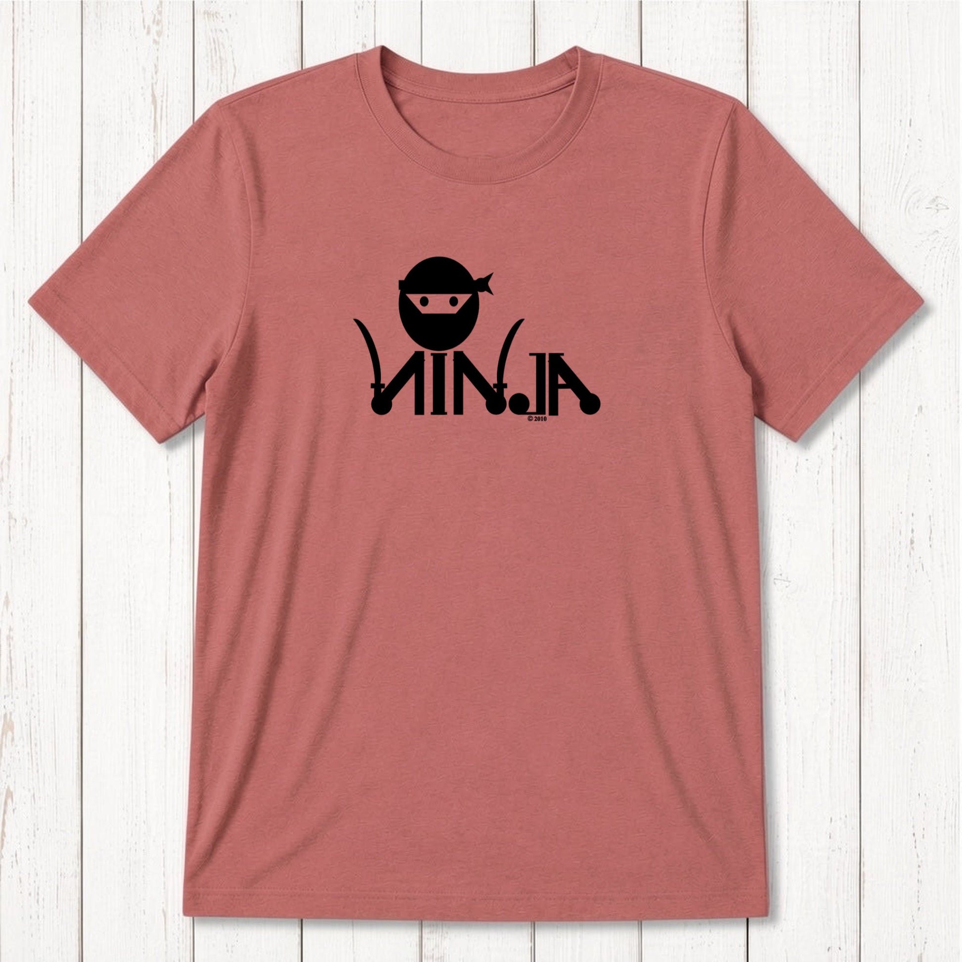 Pink men's T-shirt with black ninja graphic design featuring a ninja face with headband and stylized text, casual apparel for martial arts fans