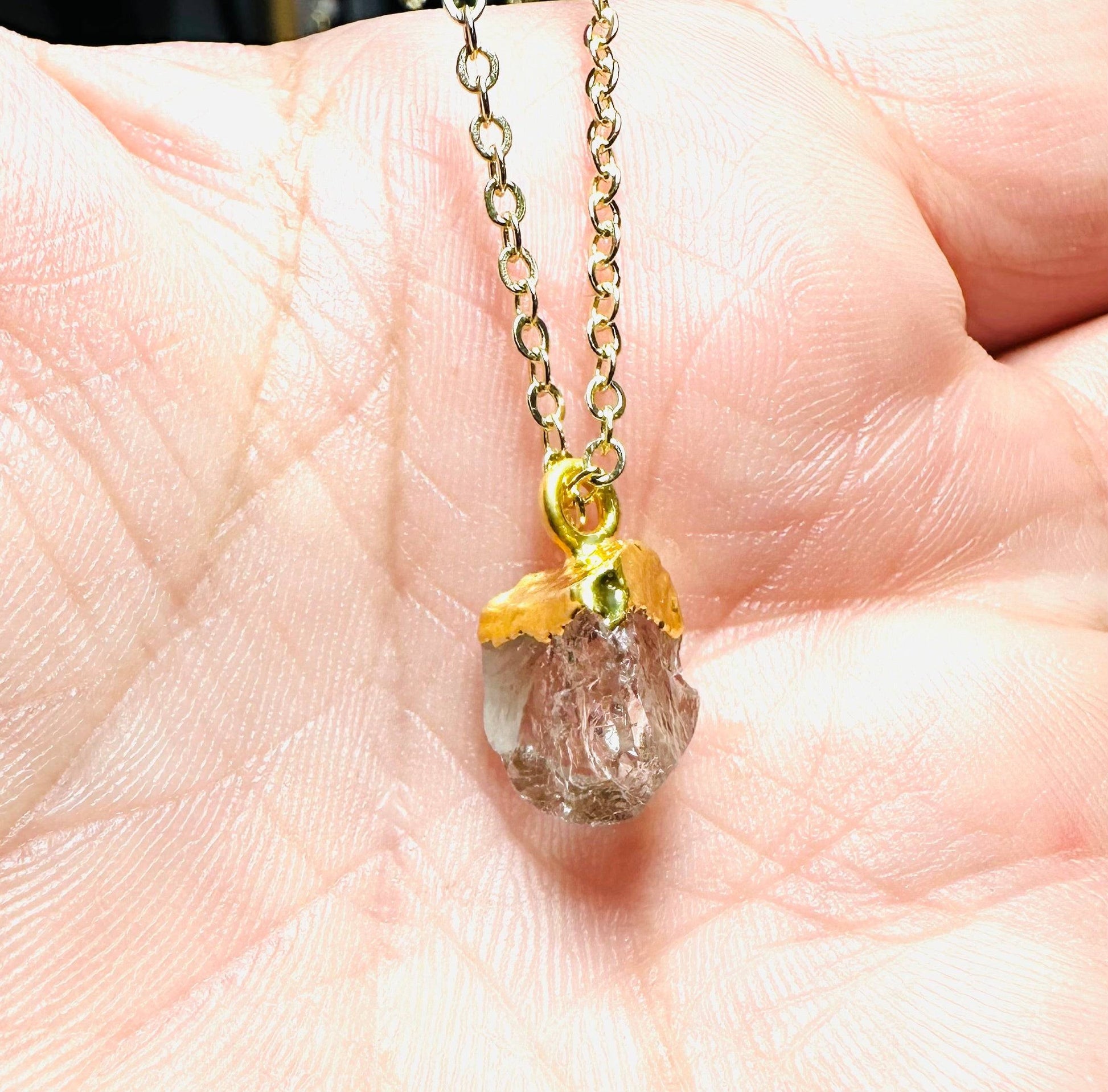Set of raw gemstone necklaces featuring aquamarine, Herkimer, and purple gemstone pendants