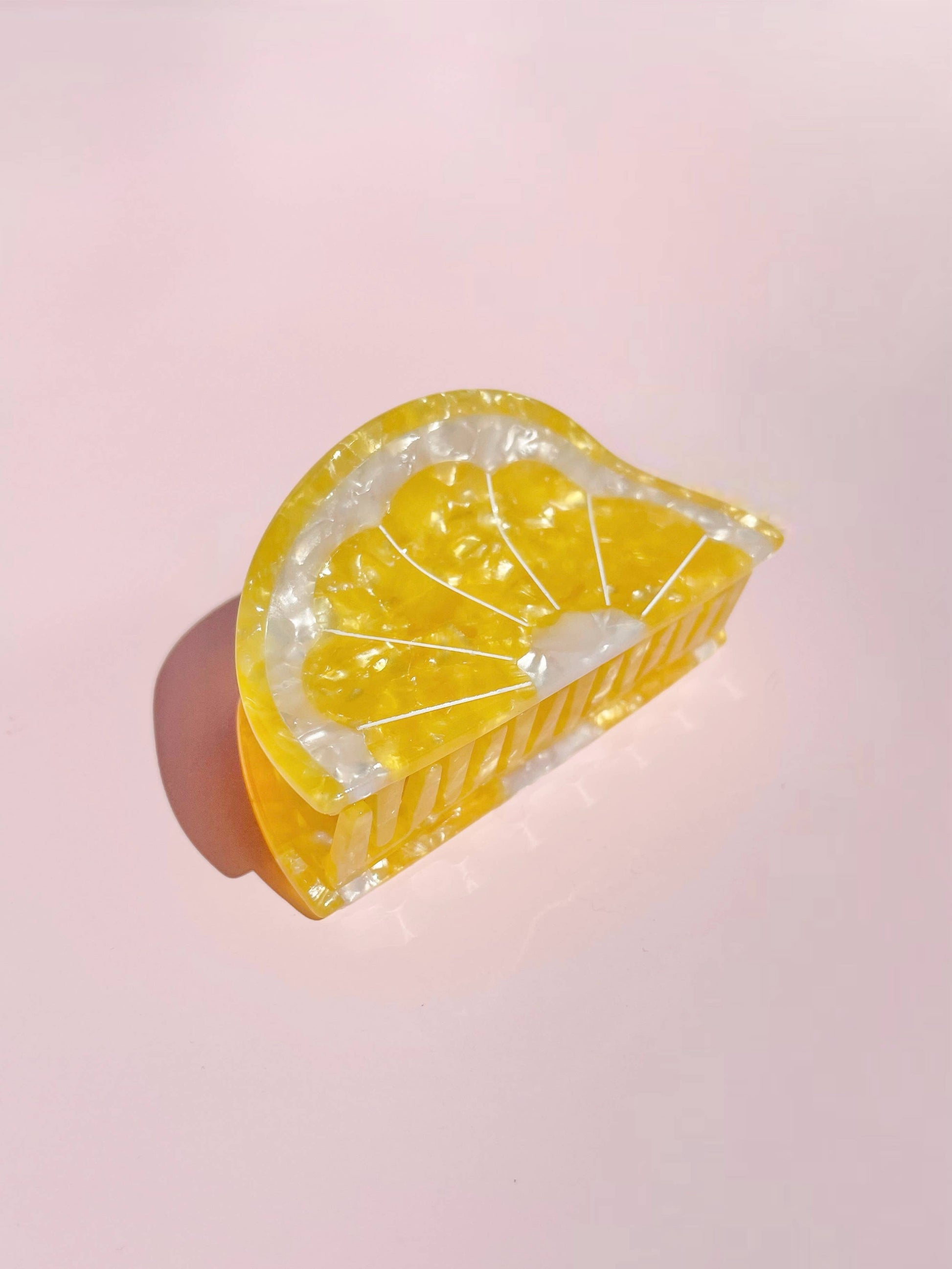 Sunshine Yellow Lemon Claw Hair Clip shaped like a lemon wedge, made from glossy cellulose acetate. A vibrant summer hair accessory.