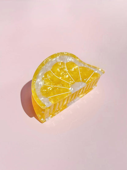 Sunshine Yellow Lemon Claw Hair Clip shaped like a lemon wedge, made from glossy cellulose acetate. A vibrant summer hair accessory.