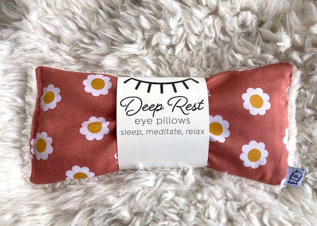 Deep Rest Eye Pillow - Relaxation & Sleep Aid on faux fur surface, featuring daisy pattern and soft fleece backing for soothing comfort.