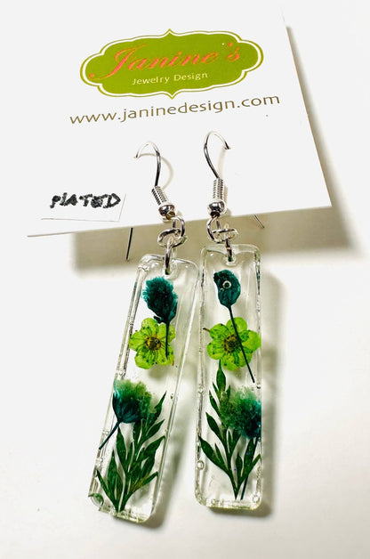 Rectangular resin earrings with green flowers and silver hooks. Botanical pressed flower earrings with a fresh, earthy vibe.