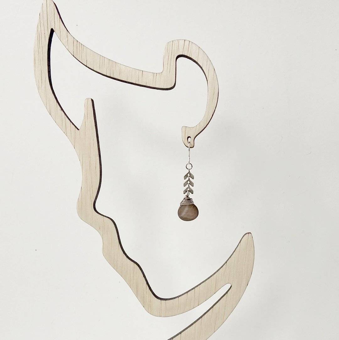 Single Abalone Chevron Earring displayed on a wooden silhouette stand, highlighting its lightweight, boho-inspired design and timeless style.