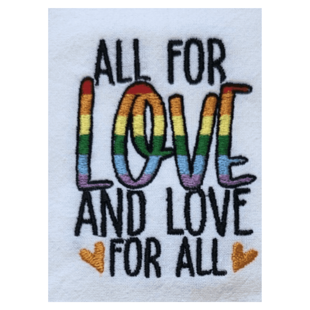 Close-up of rainbow embroidery on towel reading 'All for Love and Love for All' with two yellow hearts, ideal for gifting or kitchen decor.