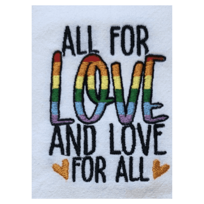 Close-up of rainbow embroidery on towel reading 'All for Love and Love for All' with two yellow hearts, ideal for gifting or kitchen decor.