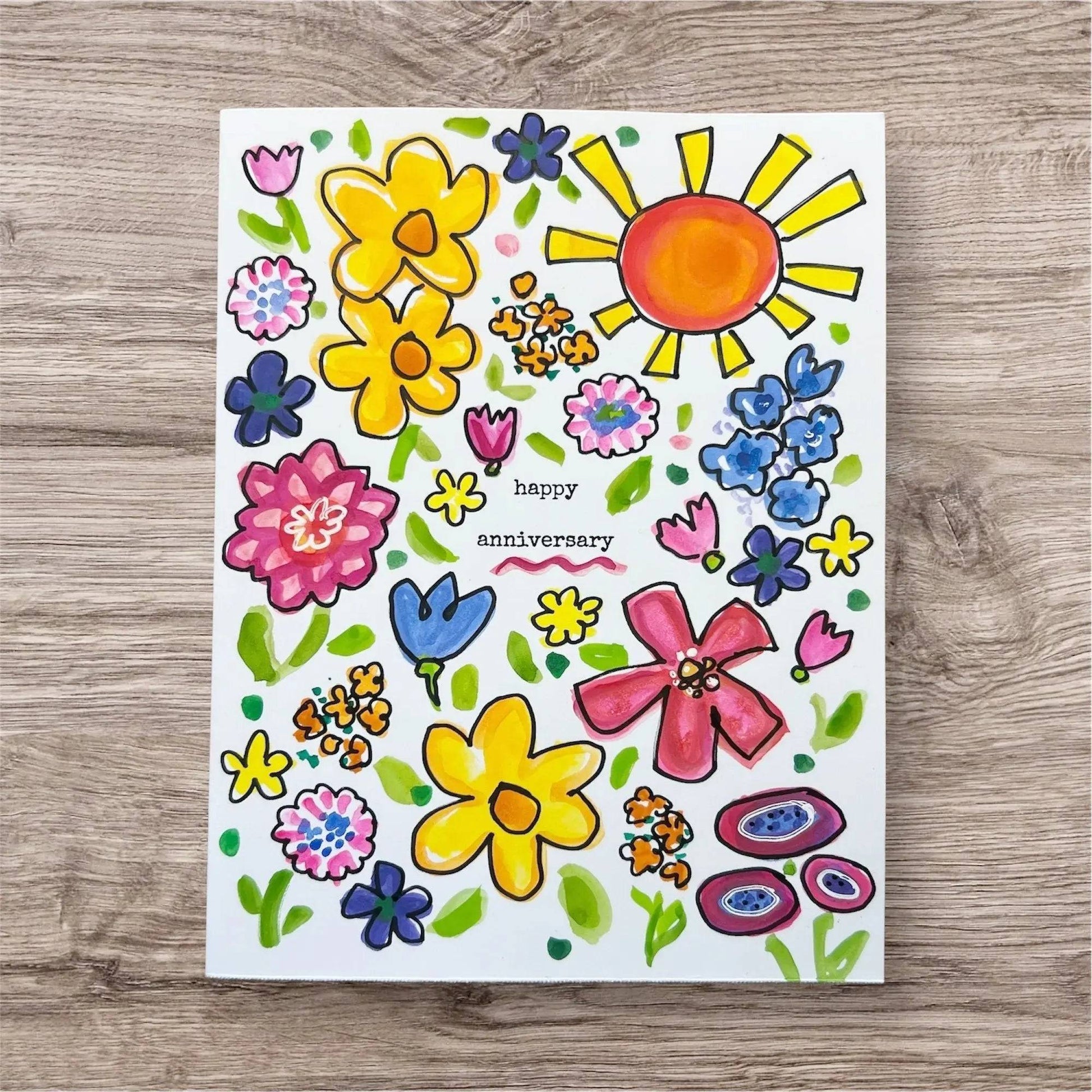 Anniversary Card - Handmade Inspirational Greeting Cards featuring colorful hand-painted flowers and sun with 'happy anniversary' text in center. Ideal for celebrating love and positivity with unique, artistic design.