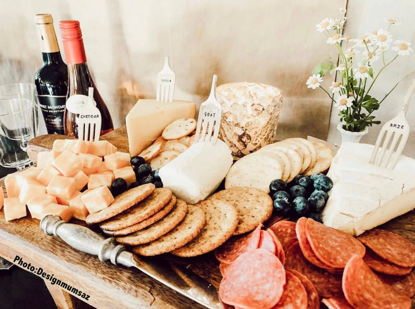Swiss Cheese Marker Set used on a charcuterie board with labeled cheeses, crackers, and fruit, showcasing practical and stylish cheese labeling.