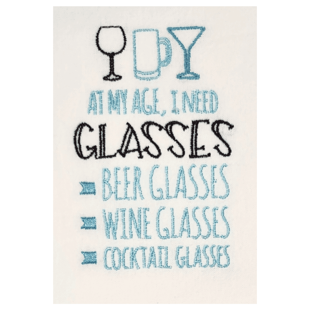 Close-up of embroidered towel text listing beer, wine, and cocktail glasses. Perfect humorous kitchen towel for gifting or home decor.