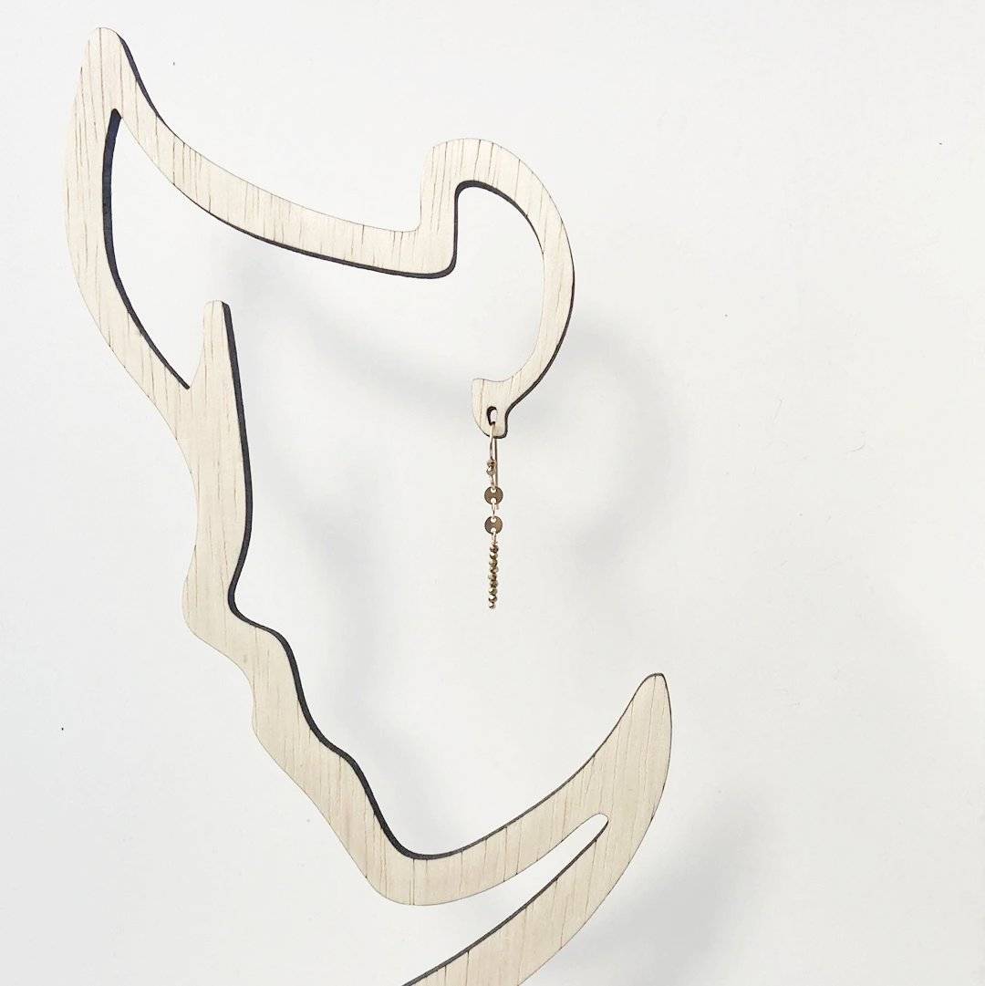 Dainty Gemstone Earrings - Gemstone Silver Earrings displayed on abstract face-shaped stand. Modern bar earrings with minimalist design appeal.