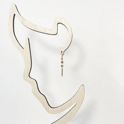 Dainty Gemstone Earrings - Gemstone Silver Earrings displayed on abstract face-shaped stand. Modern bar earrings with minimalist design appeal.