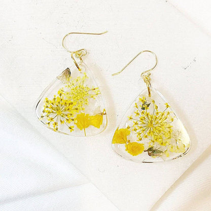 Triangle resin earrings with yellow flowers and gold hooks. Real flower design from the Pressed Flower Earrings collection.