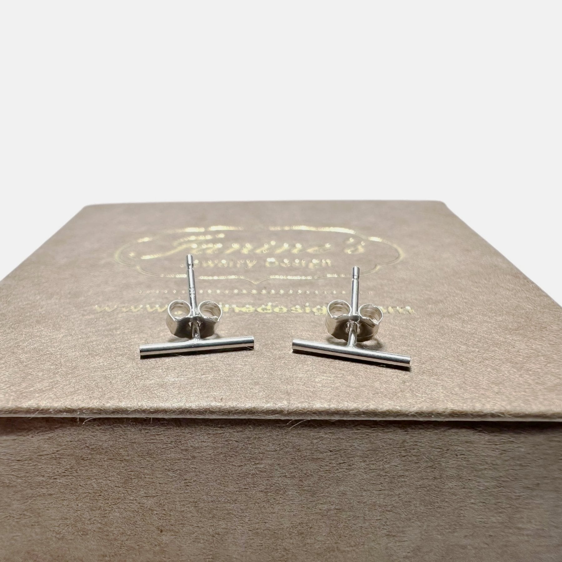 Silver bar stud earrings on jewelry box