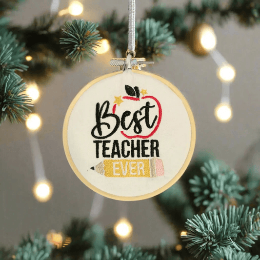 Best Teacher Ever Ornament hanging on a Christmas tree, featuring embroidered apple and pencil design. Ideal holiday decor for teacher appreciation.