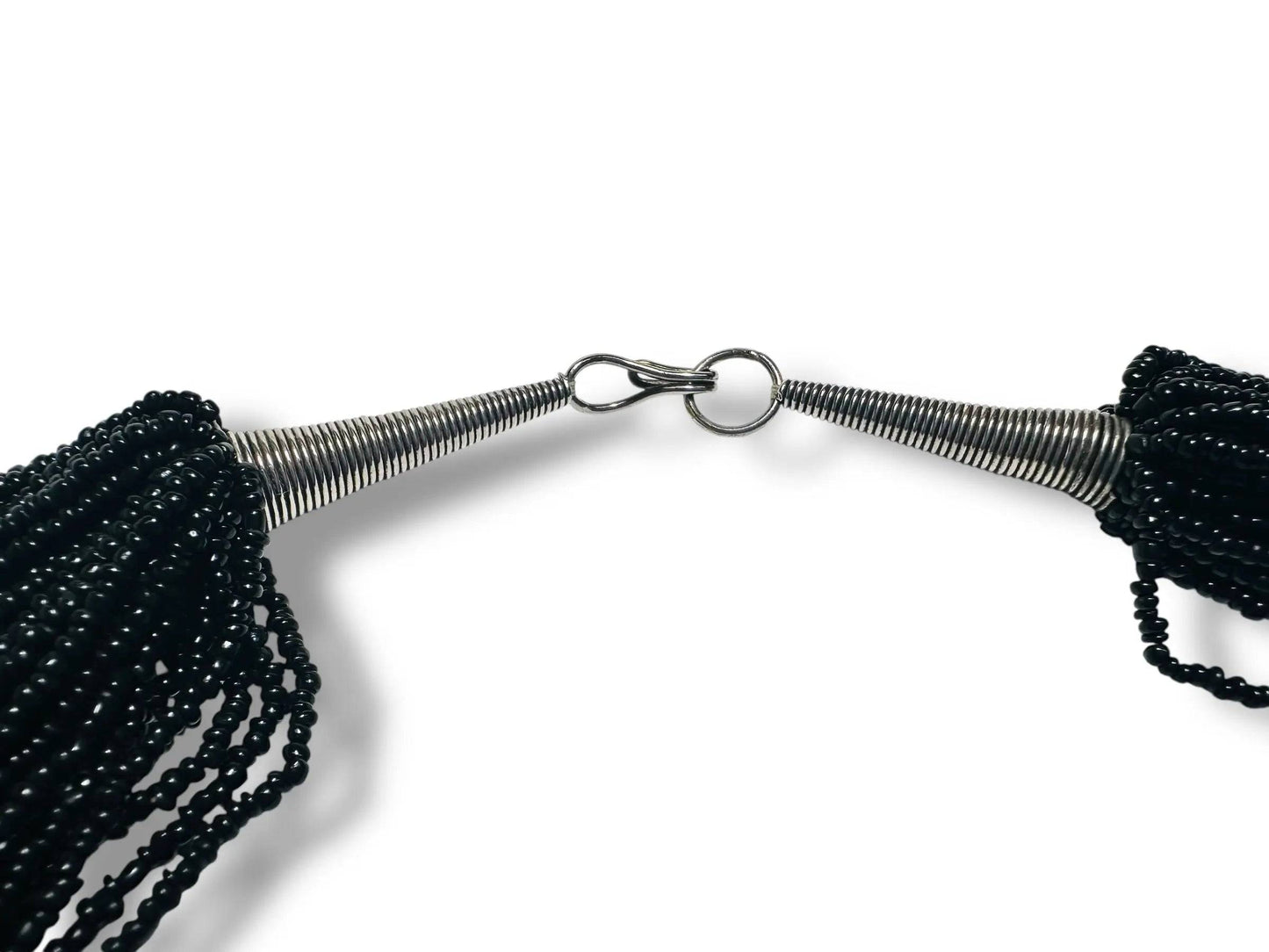 Close-up of Black Beaded Necklace clasp showing metal cone ends and hook closure, highlighting craftsmanship and vintage-inspired design.
