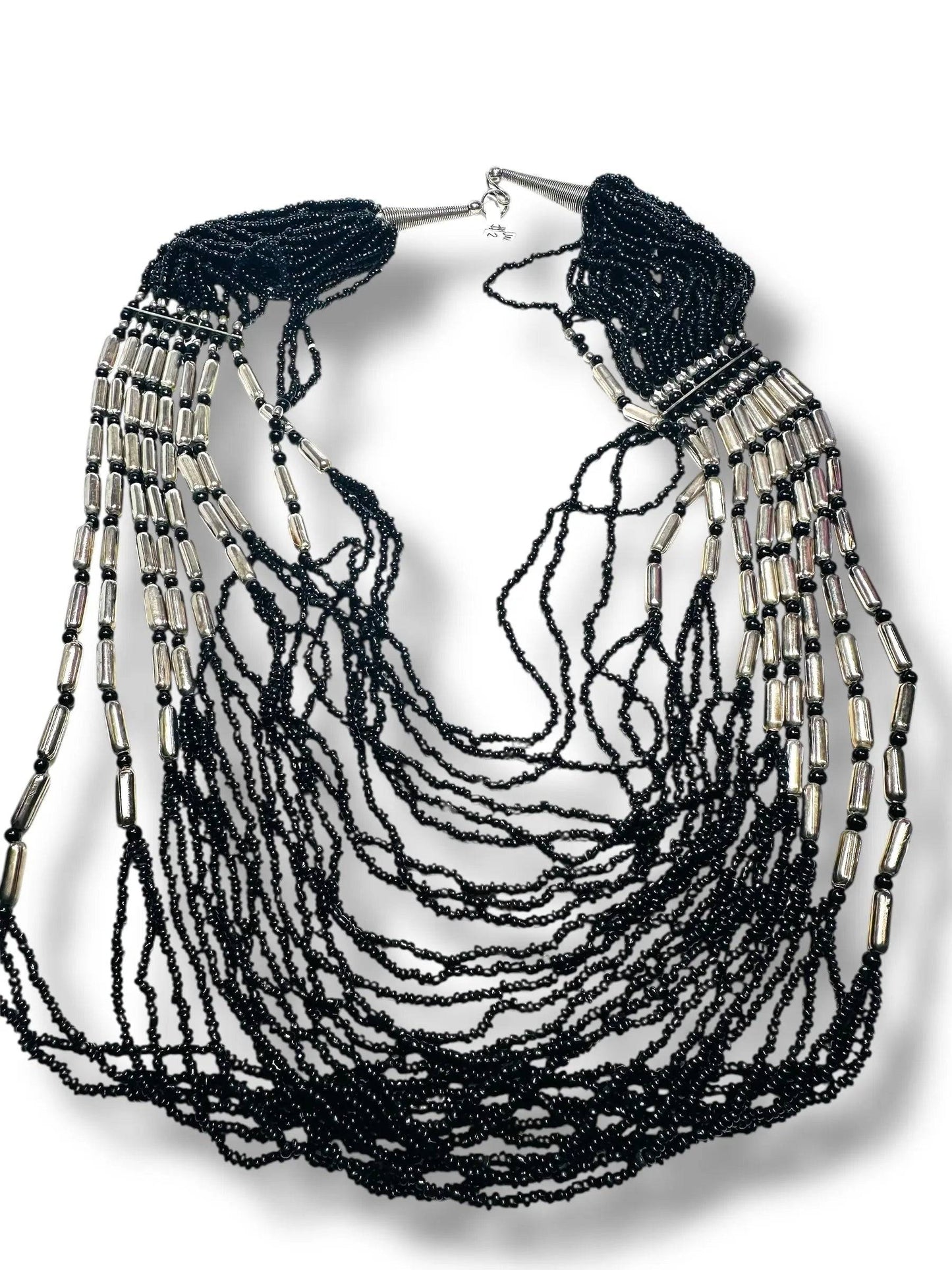 Layered black beaded necklace with metallic silver details, ideal for statement jewelry lovers in the apparel and accessories category.