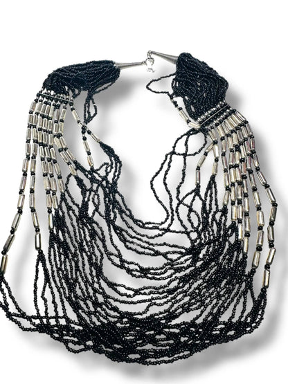 Layered black beaded necklace with metallic silver details, ideal for statement jewelry lovers in the apparel and accessories category.