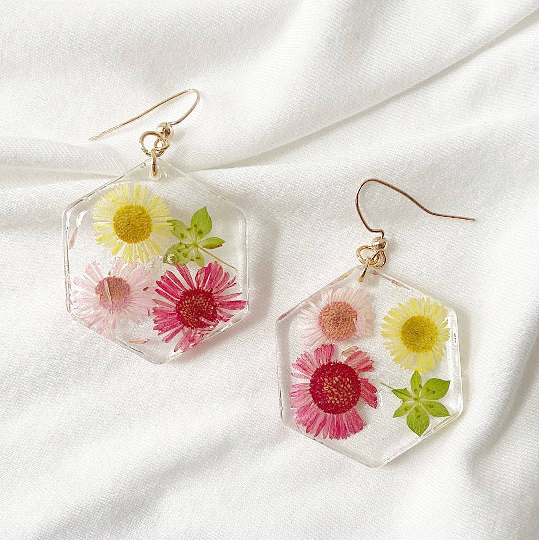 Hexagon resin earrings with pink and yellow flowers and gold hooks. Botanical jewelry from Pressed Flower Earrings - Real Flowers.