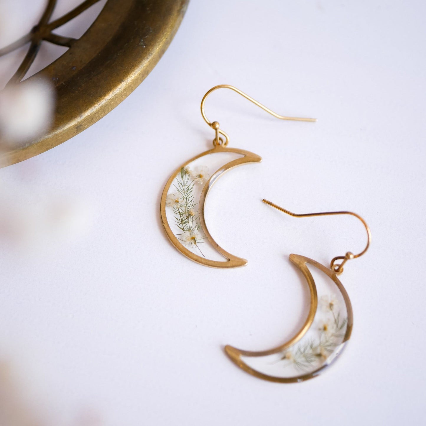 Close-up of brass Garden Flower Earrings featuring Queen Annes Lace and Asparagus ferns. Elegant crescent moon design for nature-inspired style.