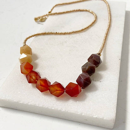 Close-up of Beaded Carnelian Necklace - Uni-T Design showcasing warm-toned faceted carnelian beads and delicate gold seed bead chain.