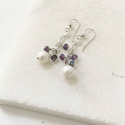 Close-up of Cultured Pearl Amethyst Earrings in sterling silver, showcasing lustrous white pearls and faceted amethyst stones in a drop design.