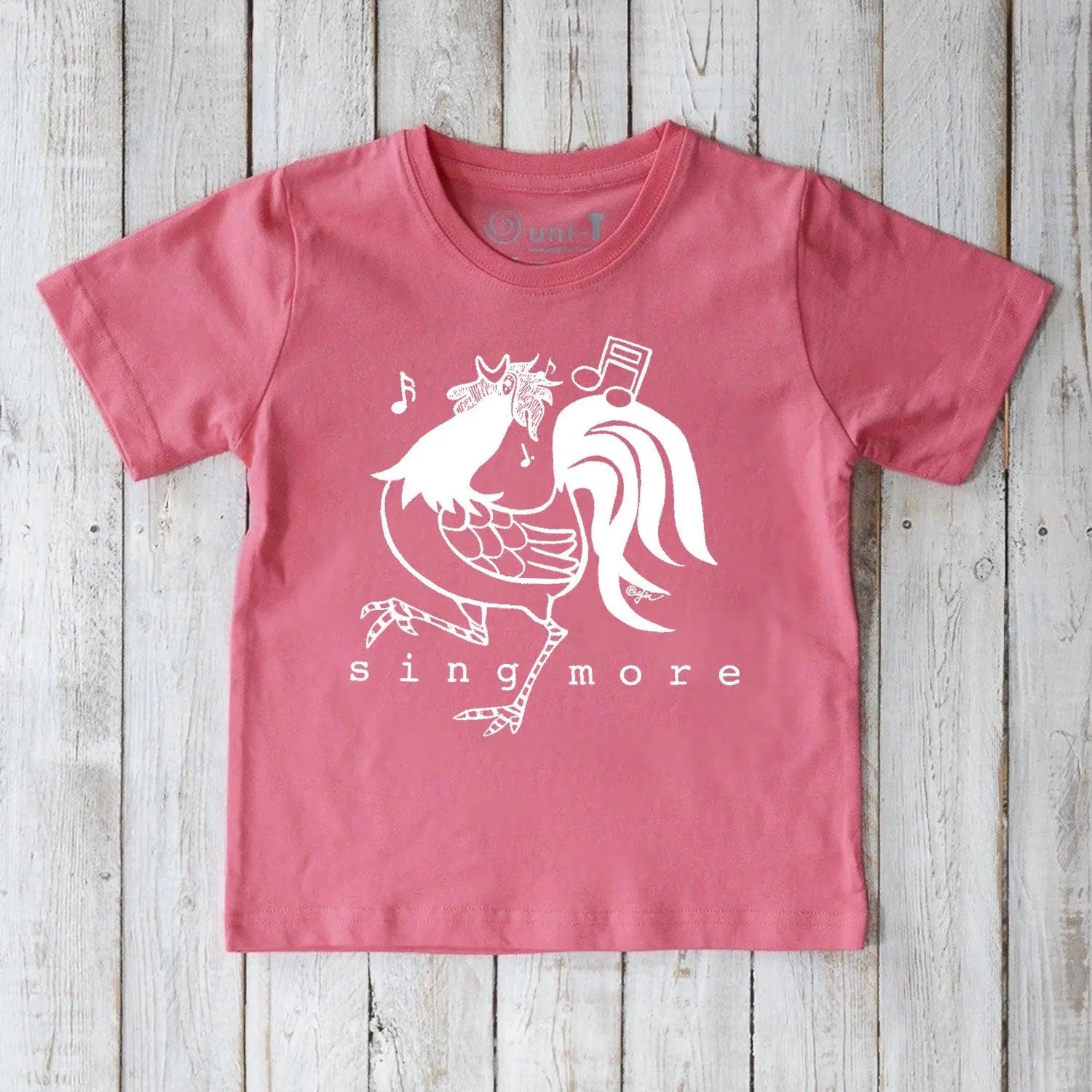 Kids' Rooster Organic Cotton T-Shirt in pink with playful 'Sing More' graphic, sustainable farm-inspired tee for children.