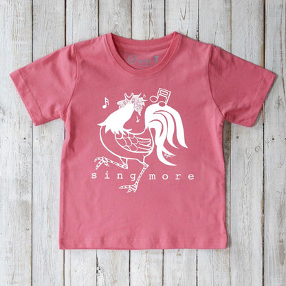 Kids' Rooster Organic Cotton T-Shirt in pink with playful 'Sing More' graphic, sustainable farm-inspired tee for children.